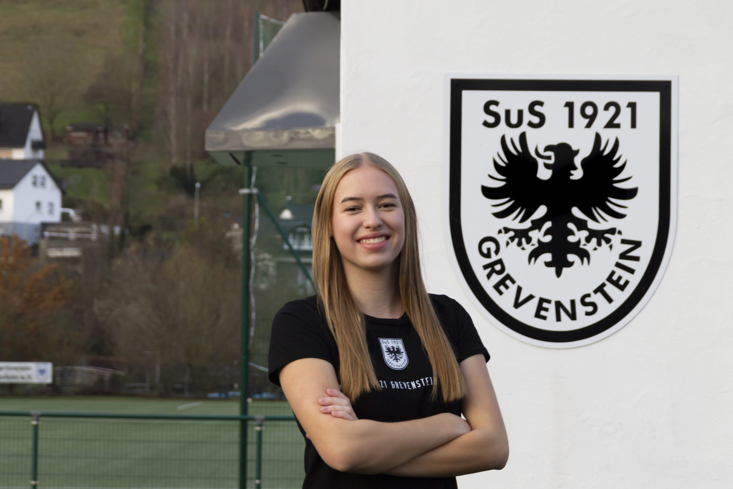 Portrait von Thea Einheuser vor dem SuS Grevenstein Wappen